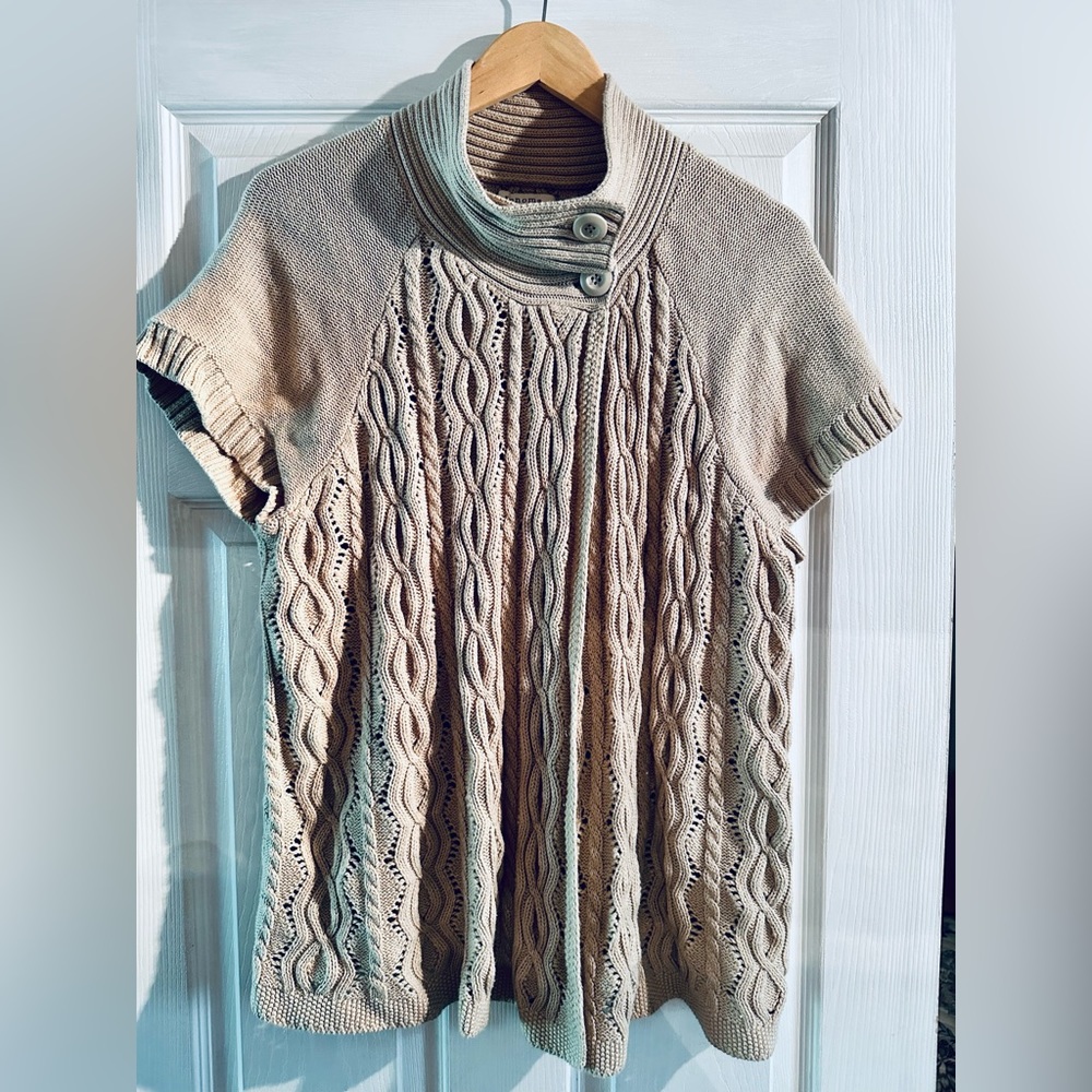 Tan sweater, buttons at neck. Swing-like, can wear open. Short sleeves. Size 1x